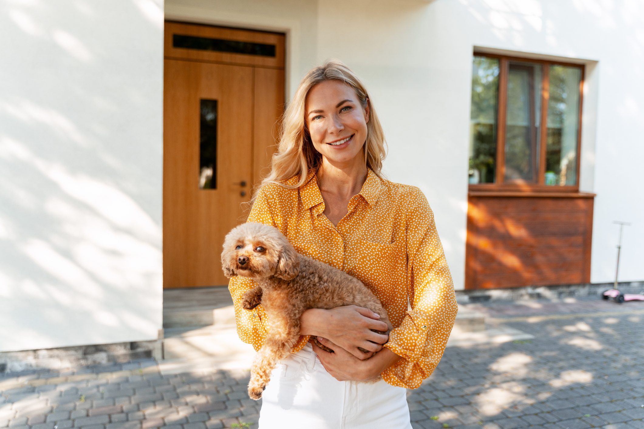 Smiling woman with curly-haired dog